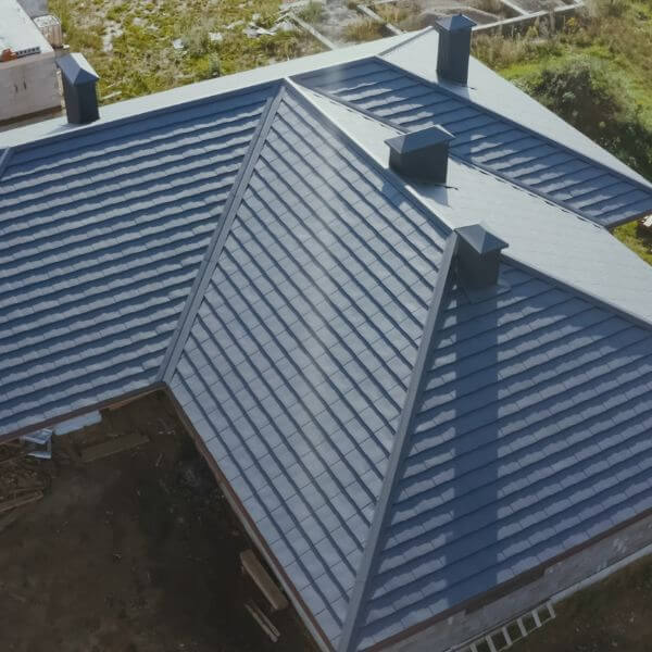 Newly installed Colorbond metal roof on a residential home completed by Roofing Guys Central Coast as part of a full metal roof replacement. Roofer from Roofing Guys Central Coast replaces damaged tiles during a full residential tile roof replacement.