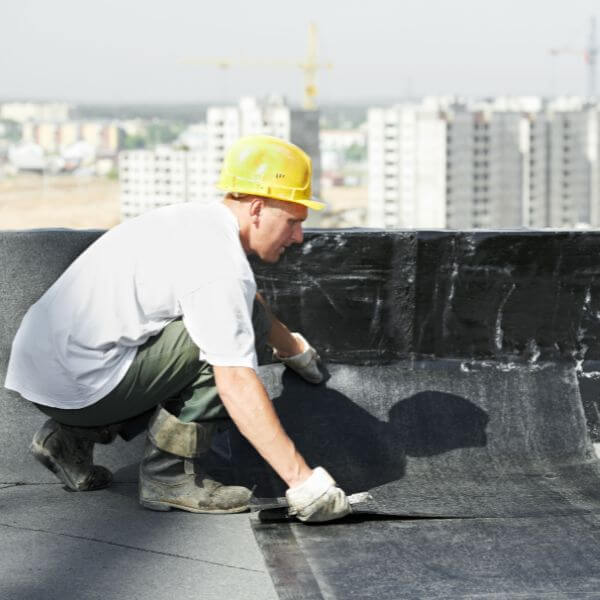 Roofing Guys Central Coast specialist applying waterproofing membrane on a commercial rooftop, part of routine strata and commercial roof maintenance services. Roofing Guys Central Coast specialist applying waterproofing membrane on a commercial rooftop, part of routine strata and commercial roof maintenance services.