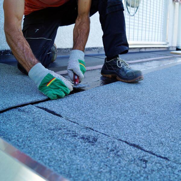 Roofing Guys Central Coast technician performing urgent commercial roof repairs using bitumen membrane on a flat roof surface in Central Coast. Roofing Guys Central Coast technician performing urgent commercial roof repairs using bitumen membrane on a flat roof surface in Central Coast.