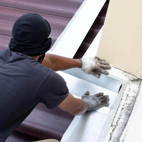 Roofing Guys Central Coast technician repairing flashing during a residential roof maintenance job in Central Coast.
