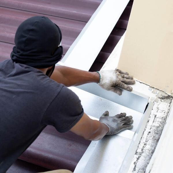 Roof repair in Kincumber by Roofing Guys Central Coast specialist re-sealing flashing at roof junctions