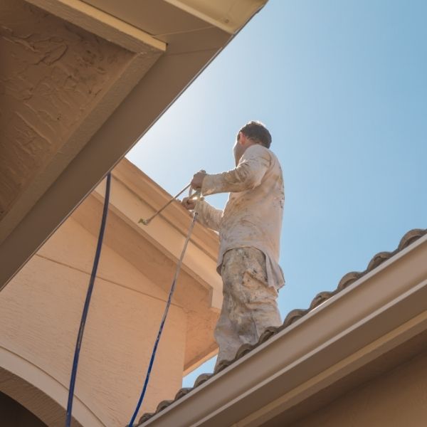 Roof painting on the Central Coast with a skilled painter applying fresh coatings for lasting protection and curb appeal.