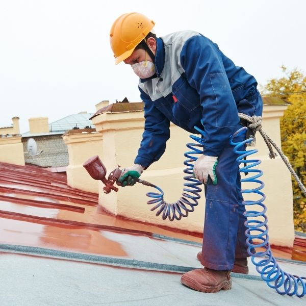 Roofing Guys Central Coast roof painting, expert roof painter applying durable paint finish on metal roof.